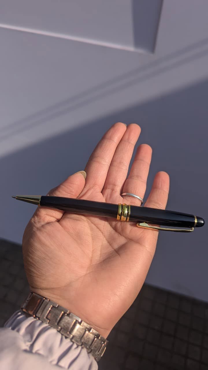 Engraved metal pen held in hand